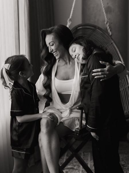 Candid of bride laughing while seated in robe during getting ready at The Ben Autograph Collection Hotel Palm Beach