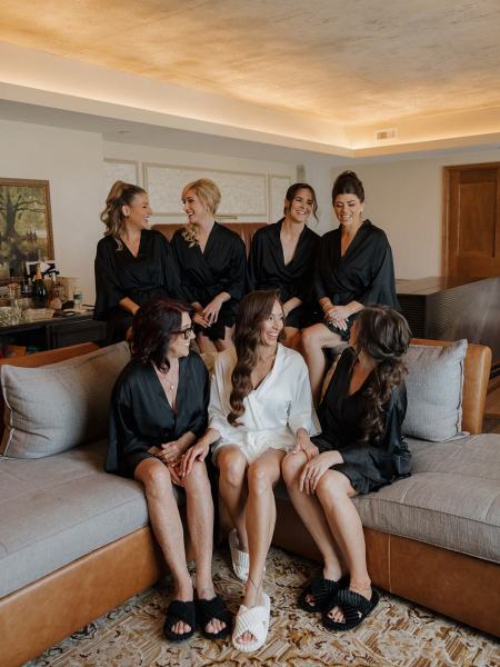 Maid of honor chatting with bride seated in robe at The Ben Autograph Collection Hotel Palm Beach