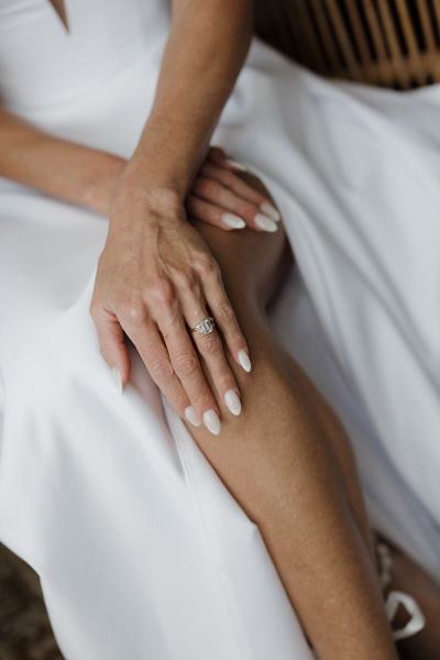 Detail of bride’s manicure and rings while holding bouquet at The Ben Autograph Collection Hotel Palm Beach