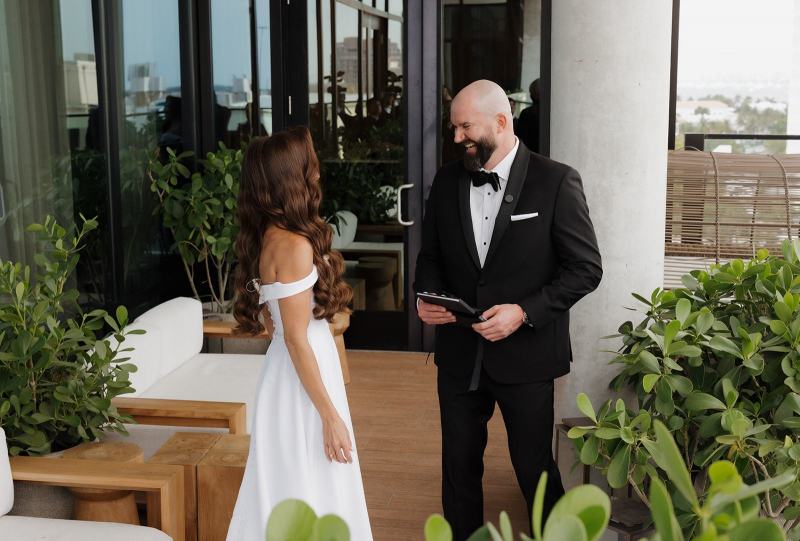 Bride and groom holding hands while exchanging vows at The Ben Autograph Collection Hotel Palm Beach