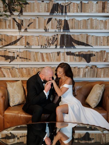 Romantic portrait of couple sitting on lobby furniture at The Ben Autograph Collection Hotel Palm Beach