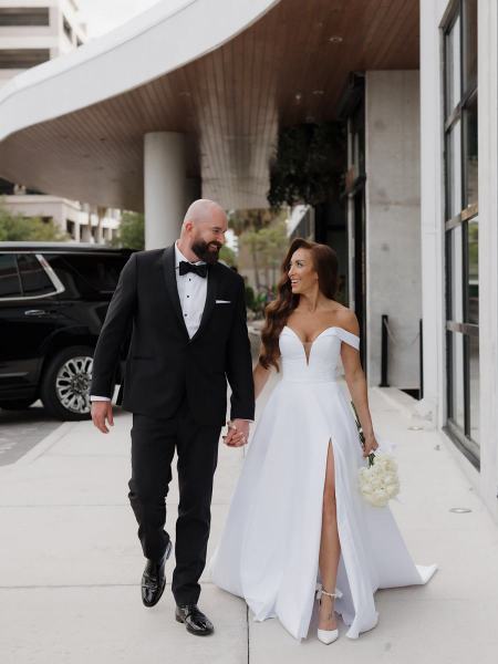 Wide shot of couple walking down pathway outside the hotel at The Ben Autograph Collection Hotel Palm Beach