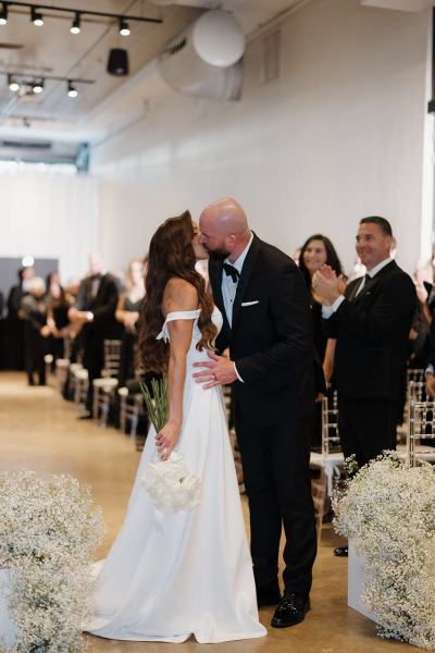 Detailed view of ceremony signage with floral accents at The Ben Autograph Collection Hotel Palm Beach