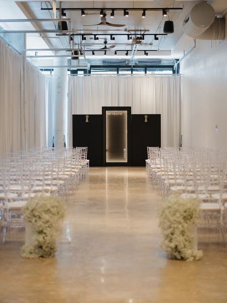 Elegant white drapes framing black altar with candles and flowers at The Ben Autograph Collection Hotel Palm Beach