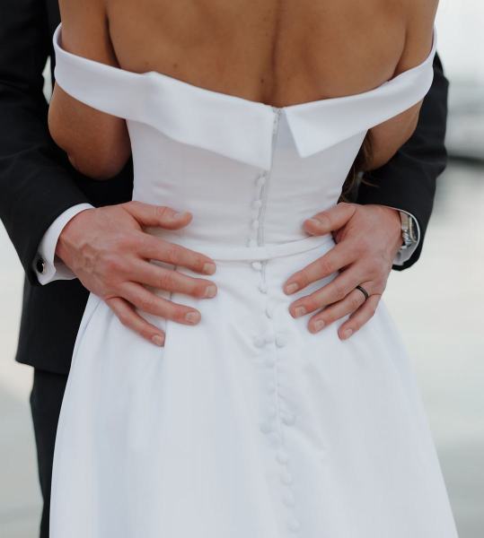 Close-up of couple smiling at each other outdoors near hotel entrance at The Ben Autograph Collection Hotel Palm Beach