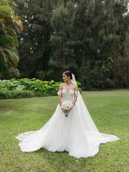 Bride adjusting veil in bridal portrait at Spanish Monastery Miami