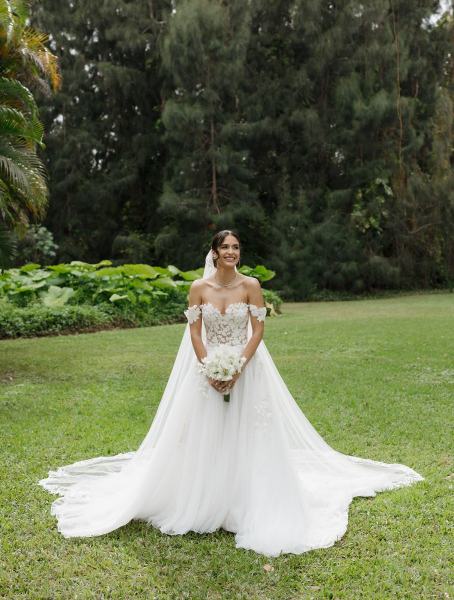 Bride adjusting veil in bridal portrait at Spanish Monastery Miami
