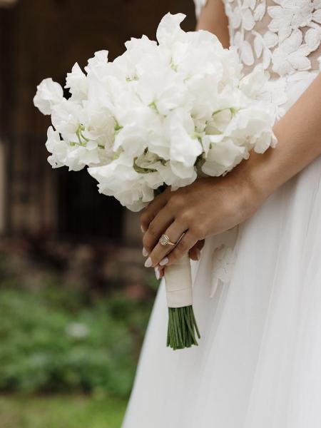 Bride holding bouquet while posing at Spanish Monastery Miami