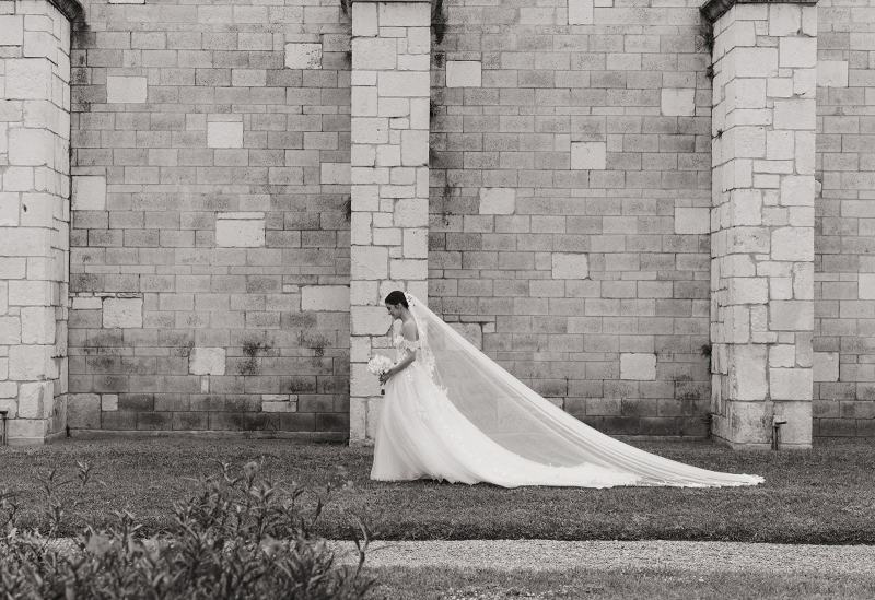 Bride standing alone in gown at Spanish Monastery Miami