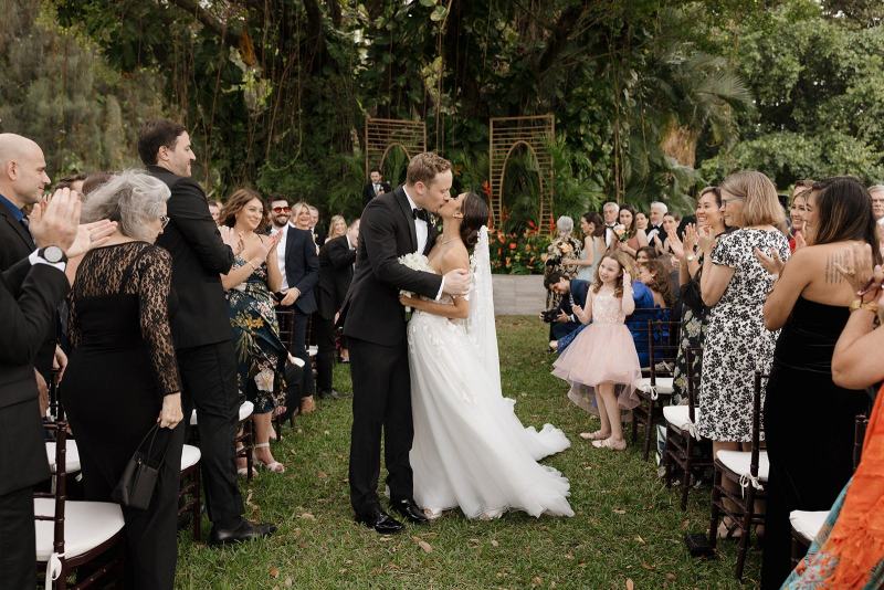 Bride and groom sharing first kiss at altar at Spanish Monastery Miami
