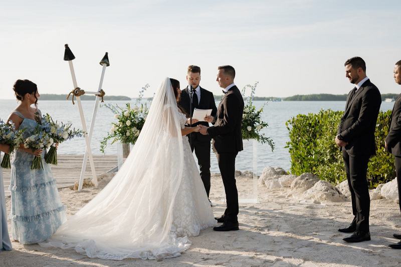 Newlyweds walking down aisle together after first kiss at Islamorada Fish Company Florida Keys
