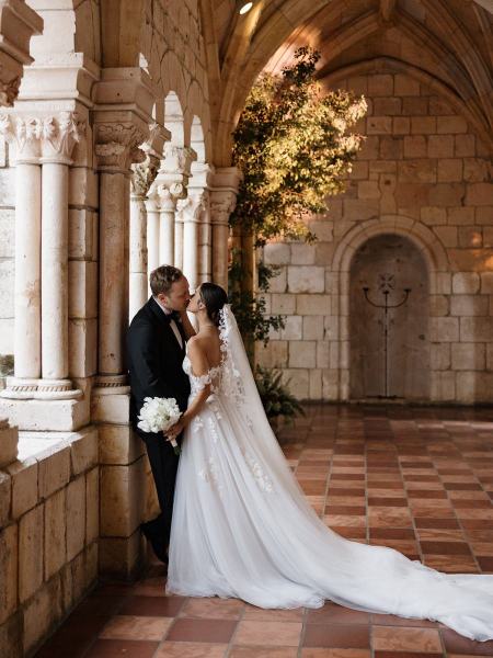 Candid of bride and groom smiling while walking down aisle at Spanish Monastery Miami