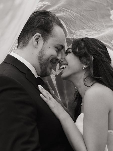 Soft-focus shot of bride and groom under veil at Cinco Farms Miami