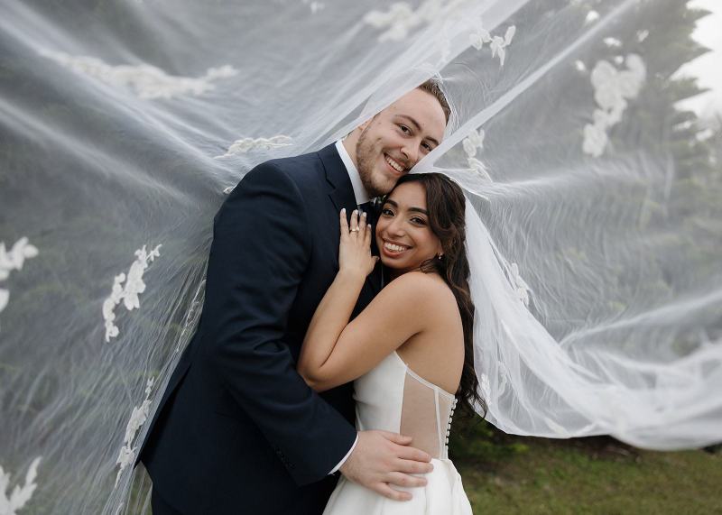 Bride looking at groom under veil at Cinco Farms Miami