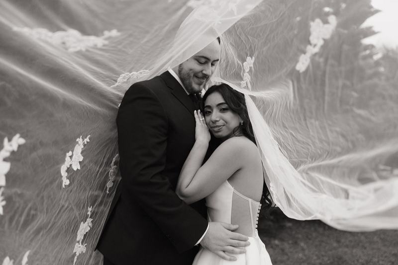 Intimate portrait of couple with veil over faces at Cinco Farms Miami