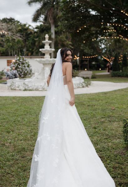 Bride and groom sharing a kiss under the veil at Cinco Farms Miami