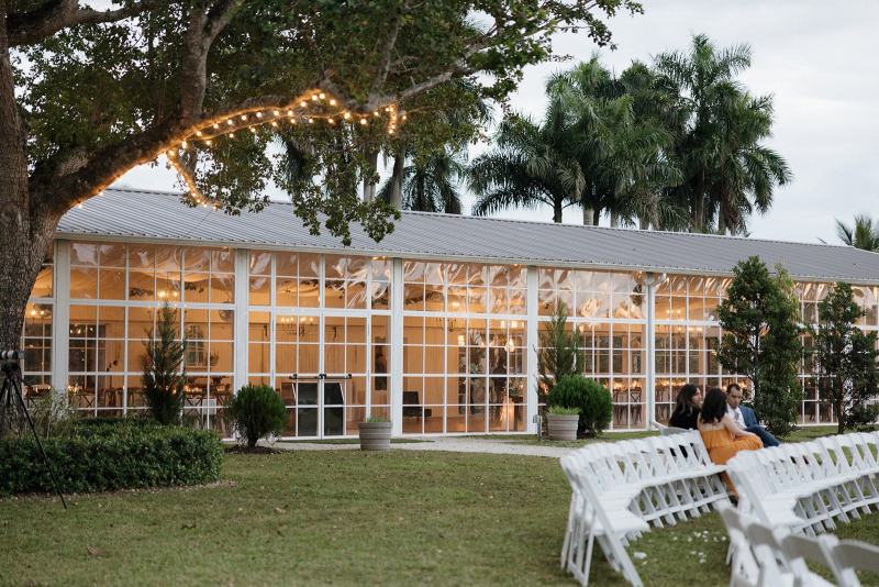 Outdoor reception setup with lanterns and lights at Cinco Farms Miami