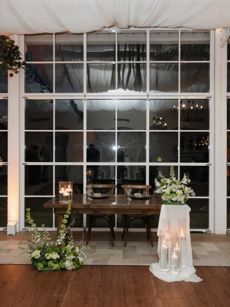 Candle glow reflecting off tables at Cinco Farms Miami reception