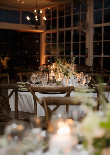 Candle glow reflecting off tables at Cinco Farms Miami reception
