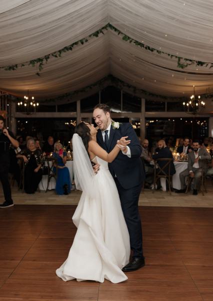 Bride spinning in groom’s arms during first dance at Cinco Farms Miami