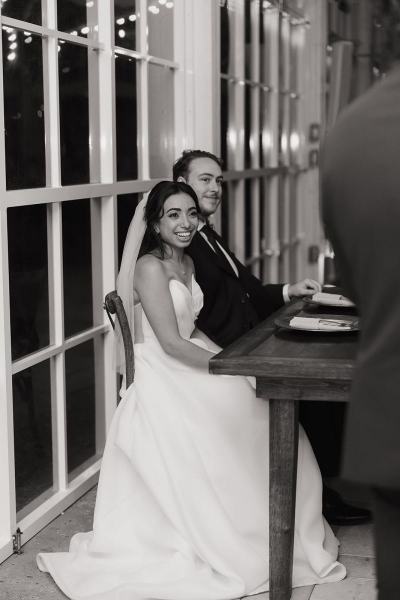 Bride and groom laughing during speech at Cinco Farms Miami wedding