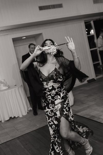 Guests taking photos of wedding cake at Cinco Farms Miami reception