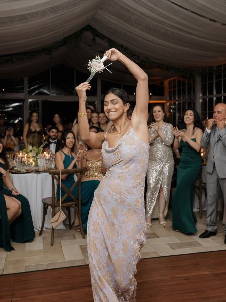 Guests taking photos of wedding cake at Cinco Farms Miami reception