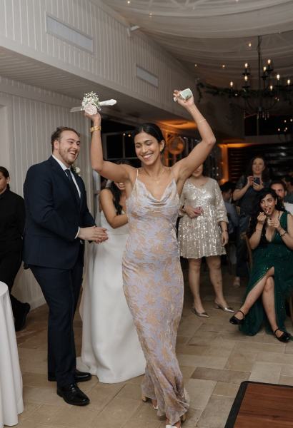 Guests taking photos of wedding cake at Cinco Farms Miami reception