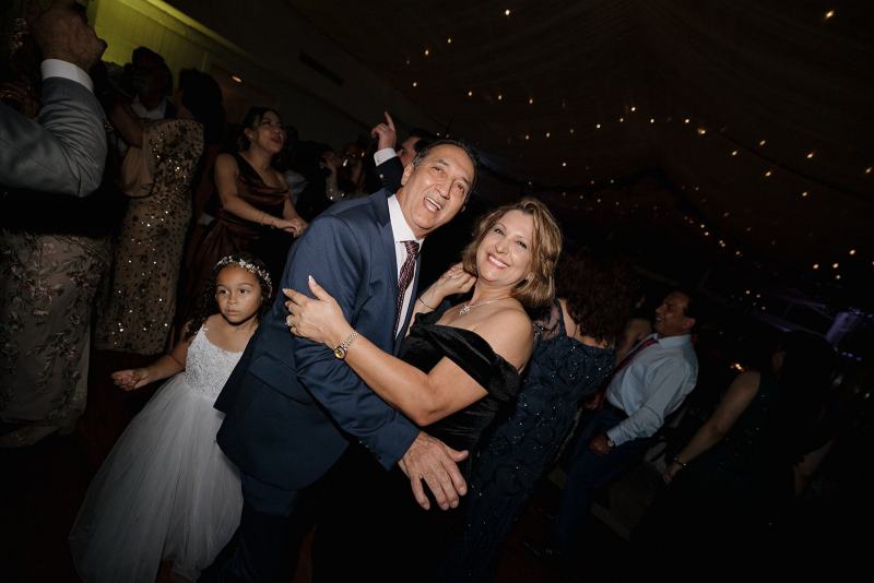 Groom laughing while dancing with friends at Cinco Farms Miami reception
