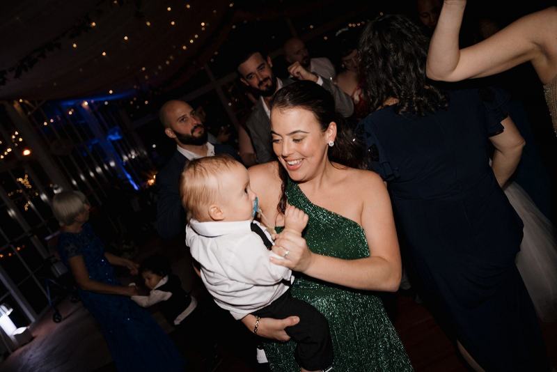 Candid moment of friends dancing at Cinco Farms Miami wedding