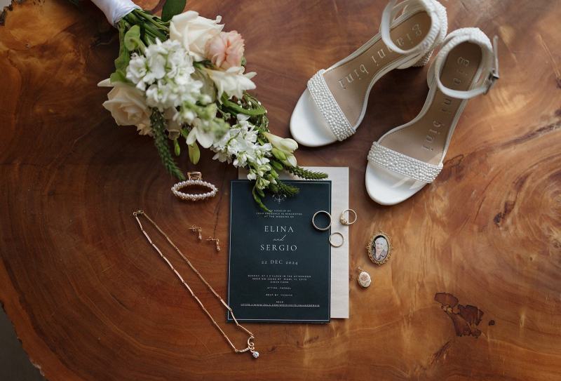 Flat lay of groom’s cufflinks and boutonniere at Cinco Farms Miami