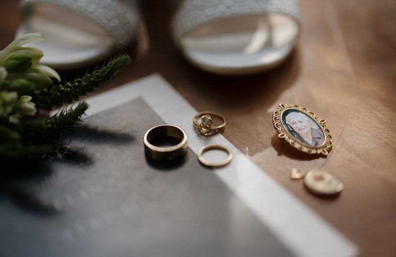 Flat lay of invitation and floral details on wood table at Cinco Farms Miami