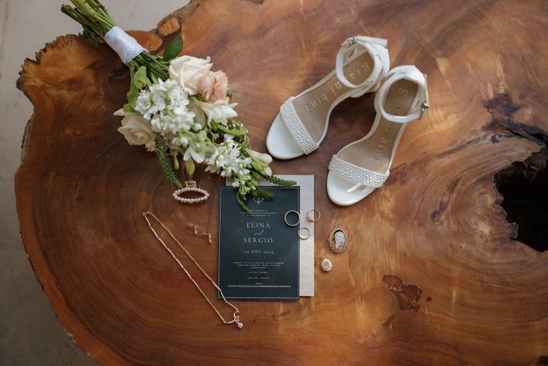 Flat lay of bride’s wedding rings on invitation at Cinco Farms Miami