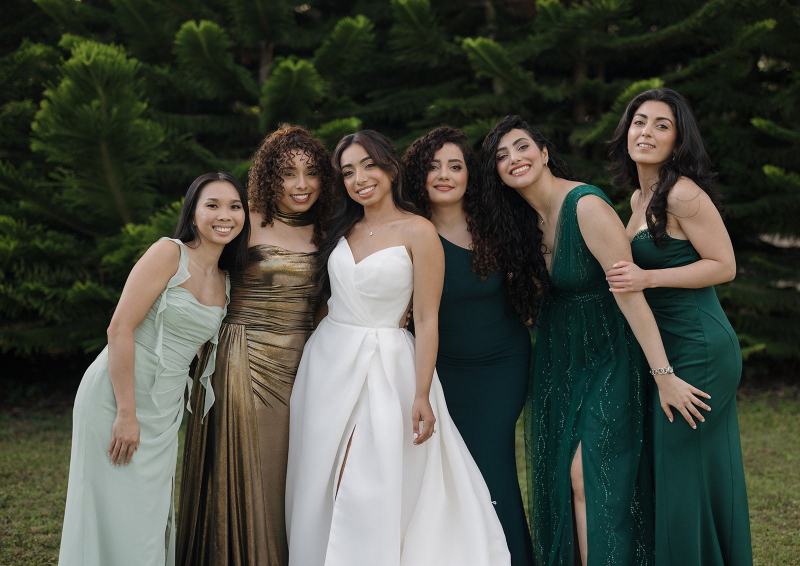Bride and bridesmaids walking down path at Cinco Farms Miami
