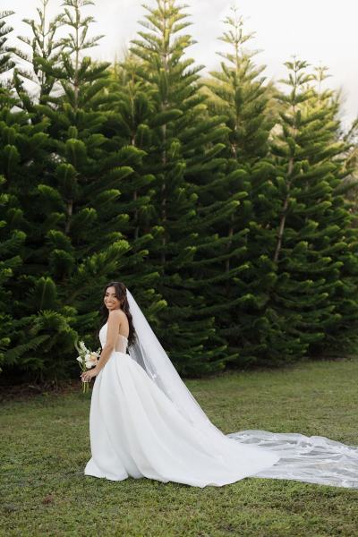 Bride leaning against wall for portrait at Cinco Farms Miami