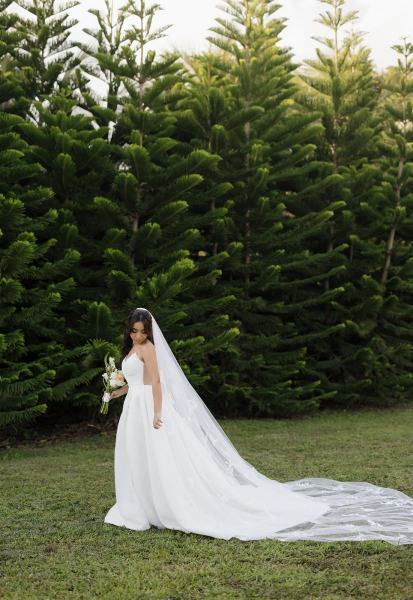 Bride standing alone in wedding dress and veil at Cinco Farms Miami