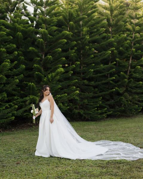 Bride leaning against wall for portrait at Cinco Farms Miami