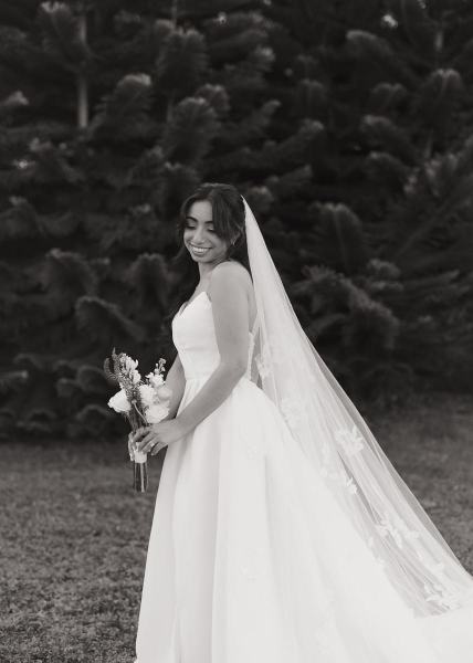 Bride leaning against wall for portrait at Cinco Farms Miami