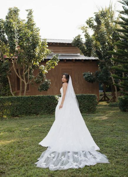 Bride leaning against wall for portrait at Cinco Farms Miami
