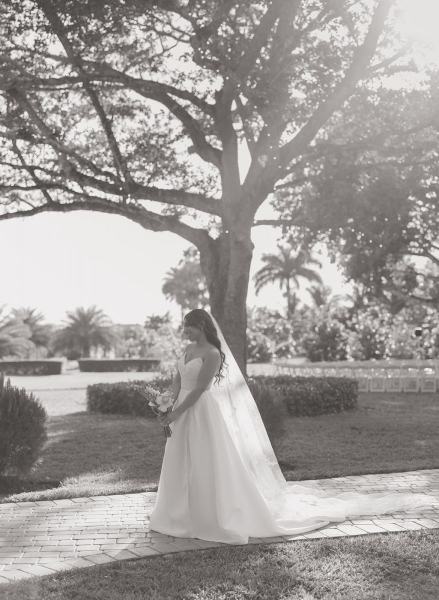 Bride leaning against wall for portrait at Cinco Farms Miami