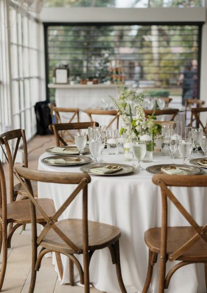 Reception tables with floral centerpieces at Cinco Farms Miami