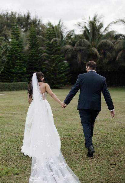 Couple holding hands for portrait at Cinco Farms Miami wedding
