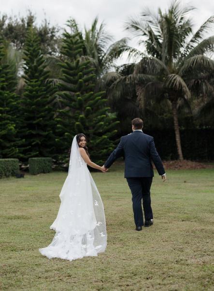 Couple holding hands for portrait at Cinco Farms Miami wedding