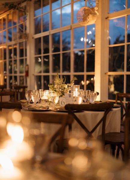 Candle glow reflecting off tables at Cinco Farms Miami reception