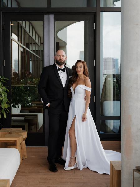 Bride and groom holding hands and smiling at The Ben Autograph Collection Hotel Palm Beach