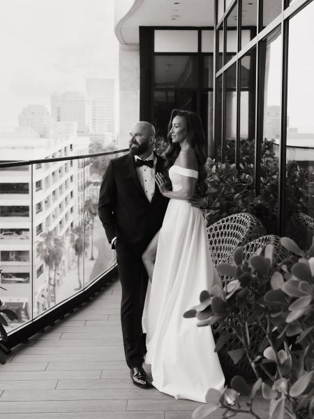 Couple walking down steps with bride’s dress flowing at The Ben Autograph Collection Hotel Palm Beach