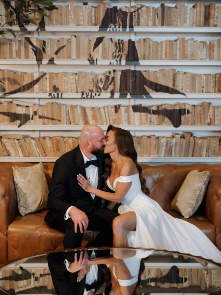 Romantic portrait of couple sitting on lobby furniture at The Ben Autograph Collection Hotel Palm Beach