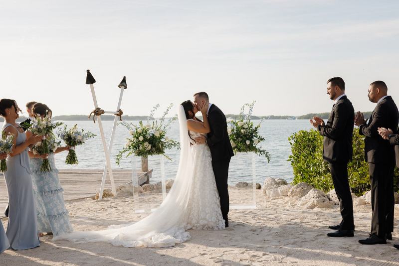 Bride and groom first kiss at altar at Islamorada Fish Company Florida Keys