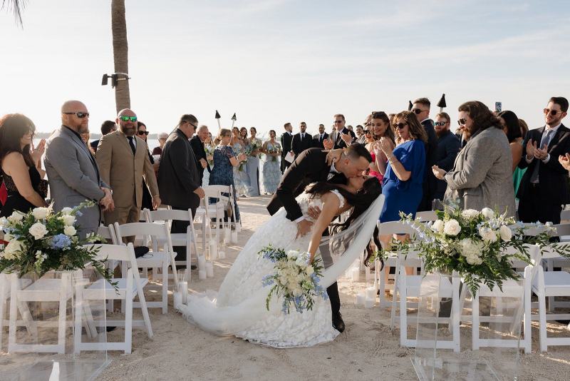 Newlyweds walking down aisle together after first kiss at Islamorada Fish Company Florida Keys